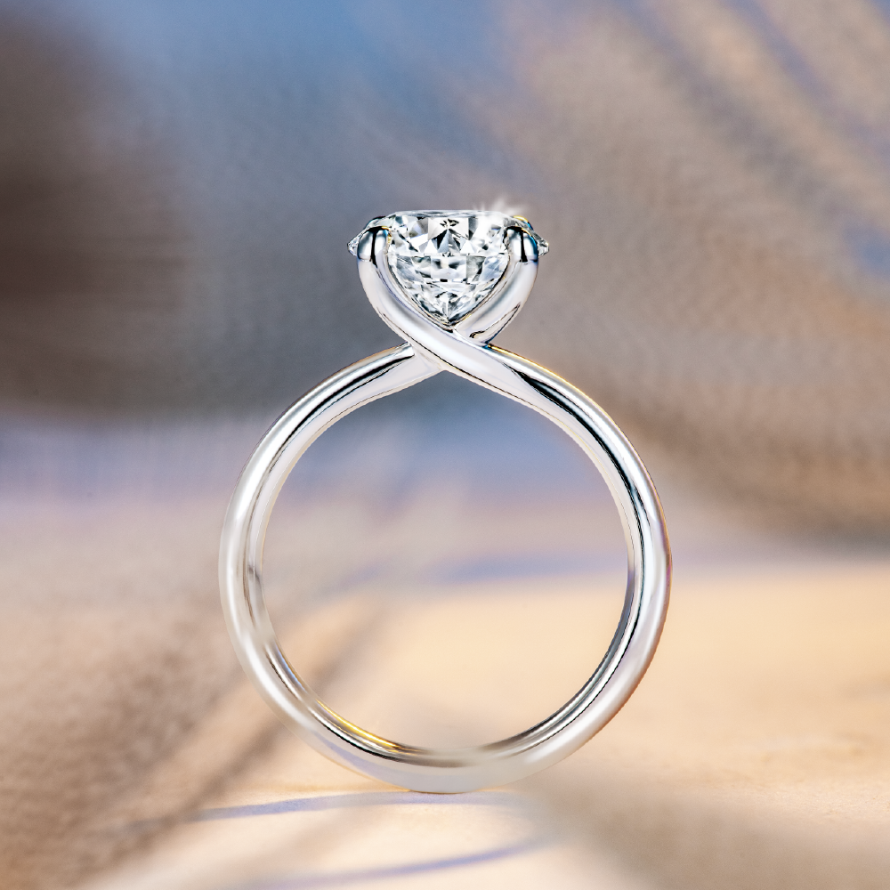 Solitaire diamond engagement ring from Hearts on Fire featuring a platinum band.